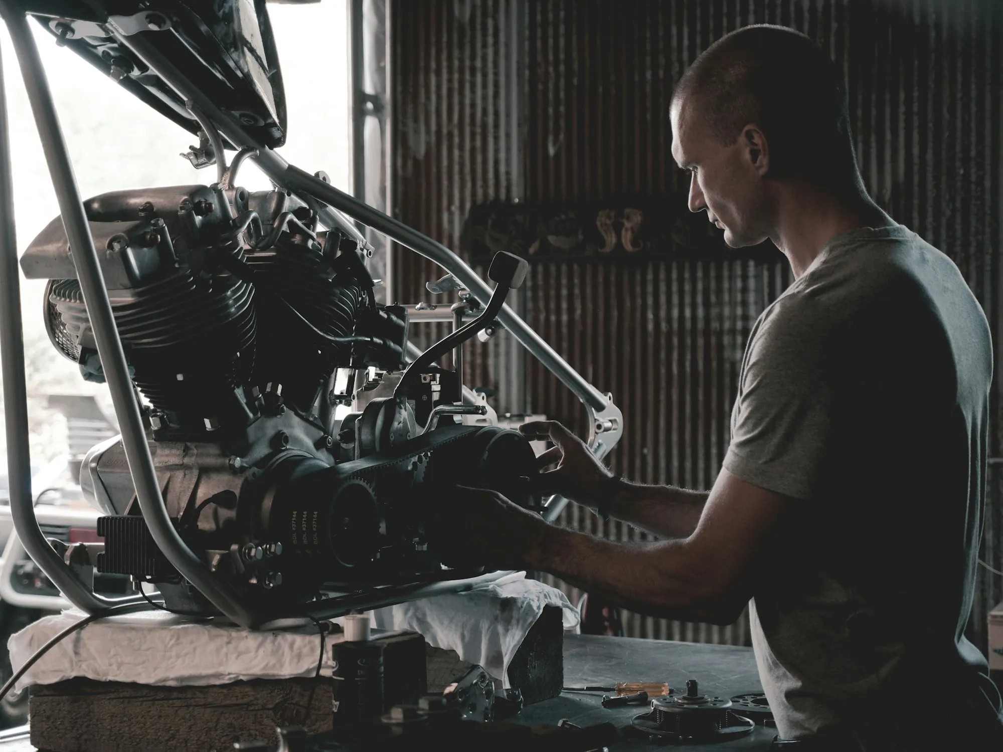Technician working at an engine on a stand in a workshop